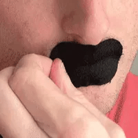 Beard-friendly mouth tape pressed over closed lips on a man with stubble